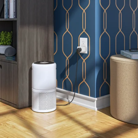 A vertical air purifier placed in a home office in consumer electronics.