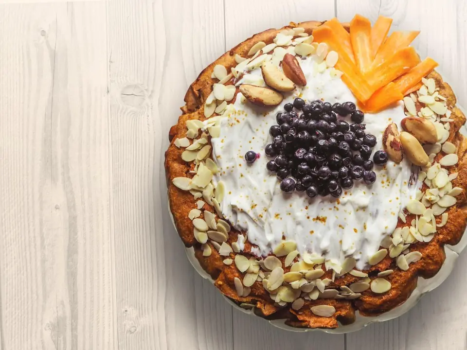 A dessert plate topped with nuts and fruits, rendered with 3D rendering quality assurance for food presentations.